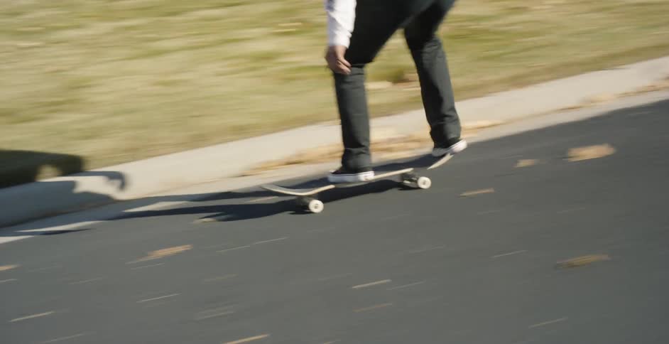 Man Skateboarding Around City