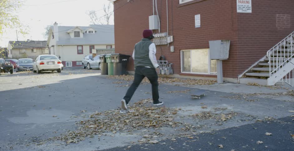 A skateboarder falling off a railing after trying to grind down