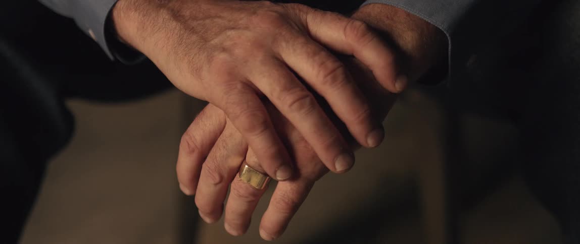 A person has their hands clasped together