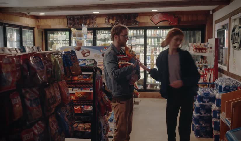 A man and woman run out of a store with stolen food