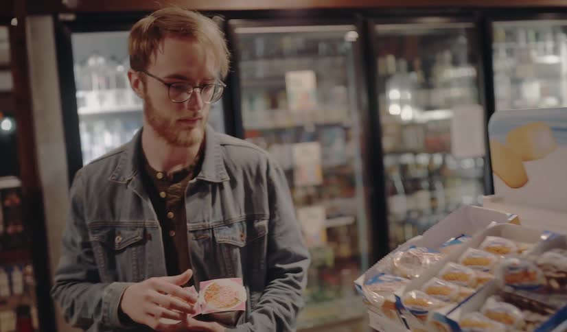 A man looking around him at a convenience store