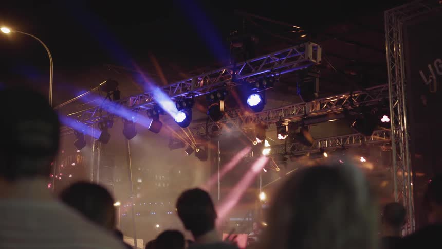 Lights illuminate from a concert stage