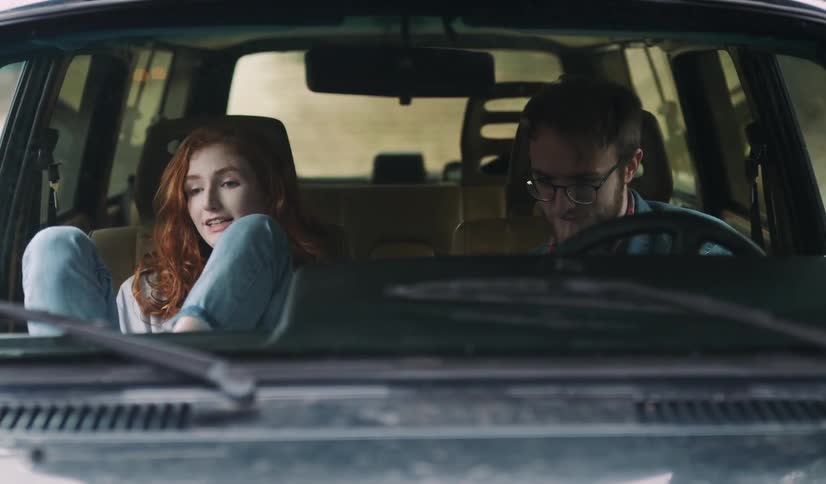 A man and woman are in a car together