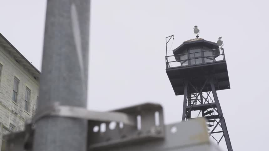 The watch tower sits by the prison