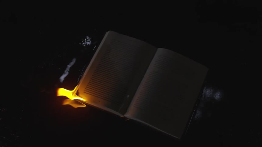 Corner of a book on fire