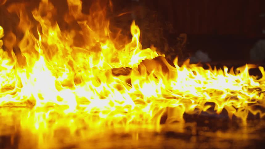 Doll burns on the ground at night