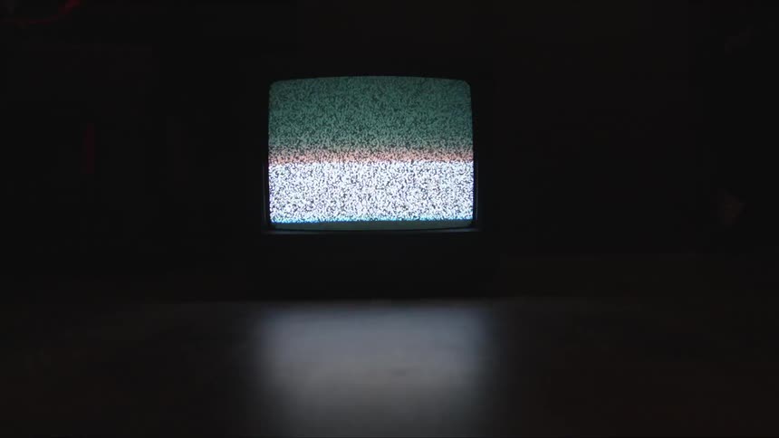A crt tv on in a dark room