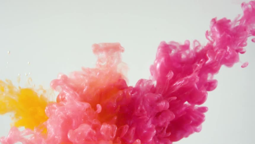 Pink and orange streams of paint flow into water and crash together