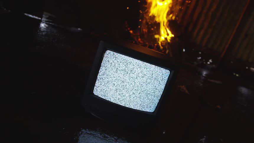 A television is full of static in the abandoned building