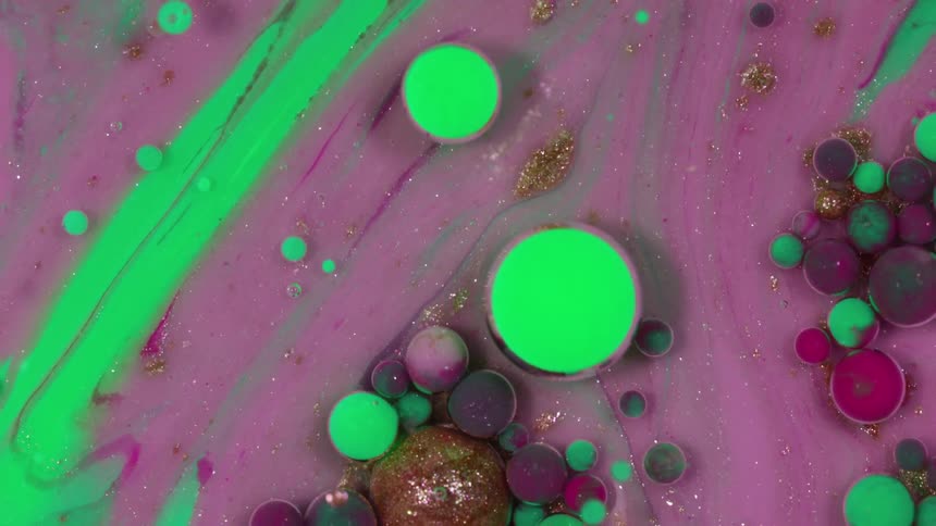Different colored paint dots swirl around