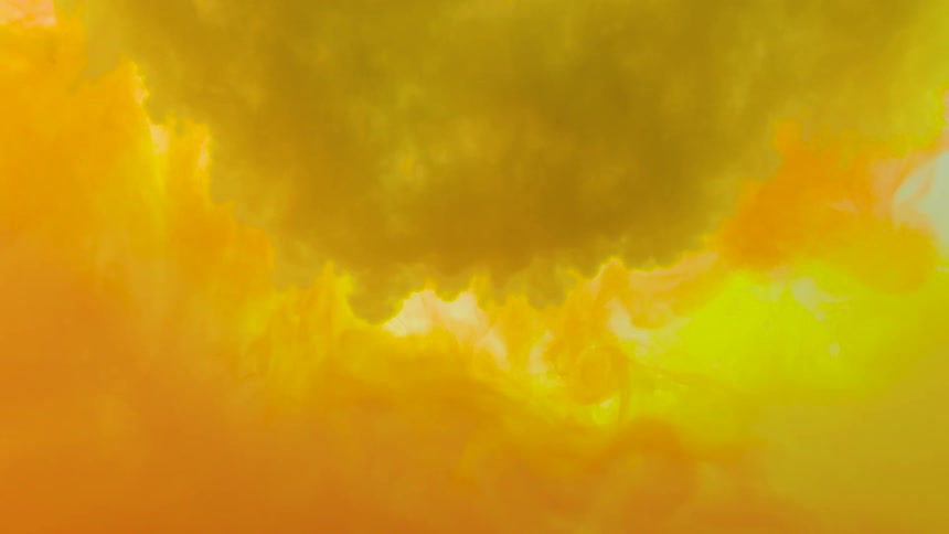 Yellow paint pouring into water