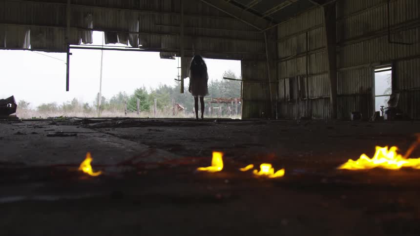 A person is watching a fire burn