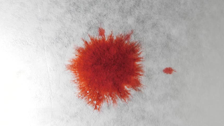 A red spot falls on the paper