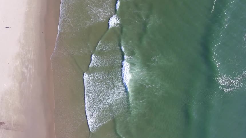 Waves are moving along the beach