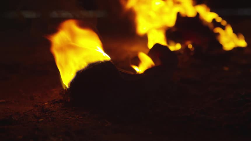 Flames burning on an object on the ground