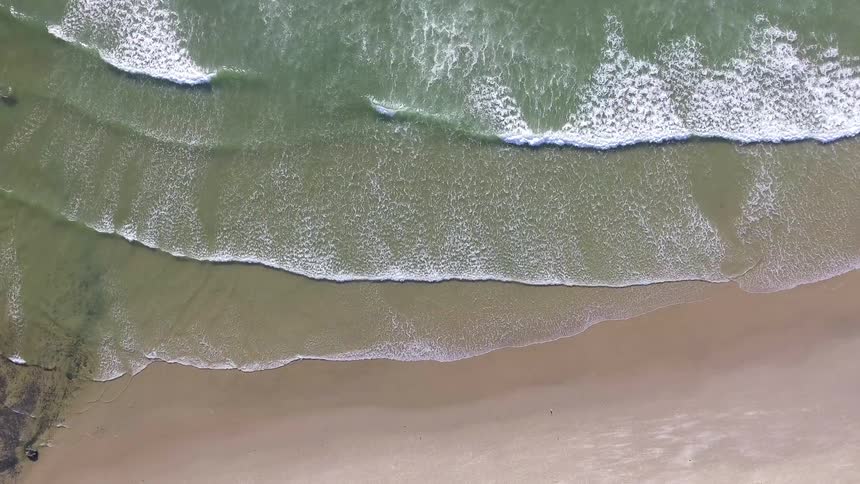 Waves rolling onto a shallow beach