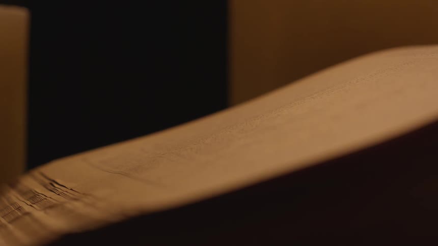 Pages of a book are being placed together