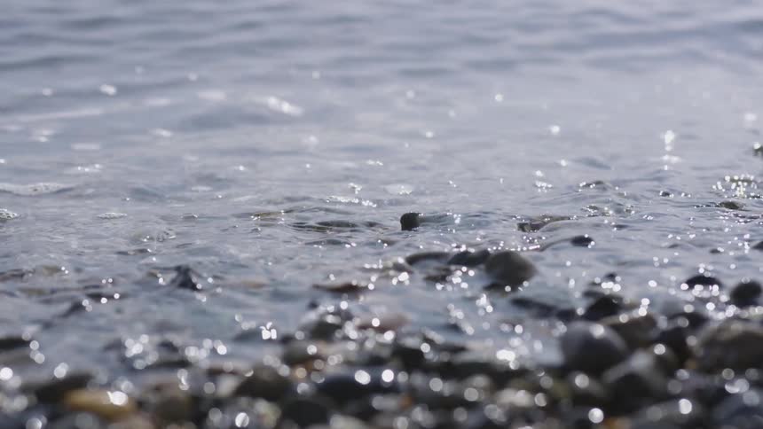 Waves on a rocky beach at midday