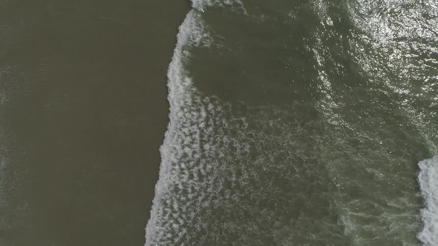 Waves of an ocean flow gently to the shore