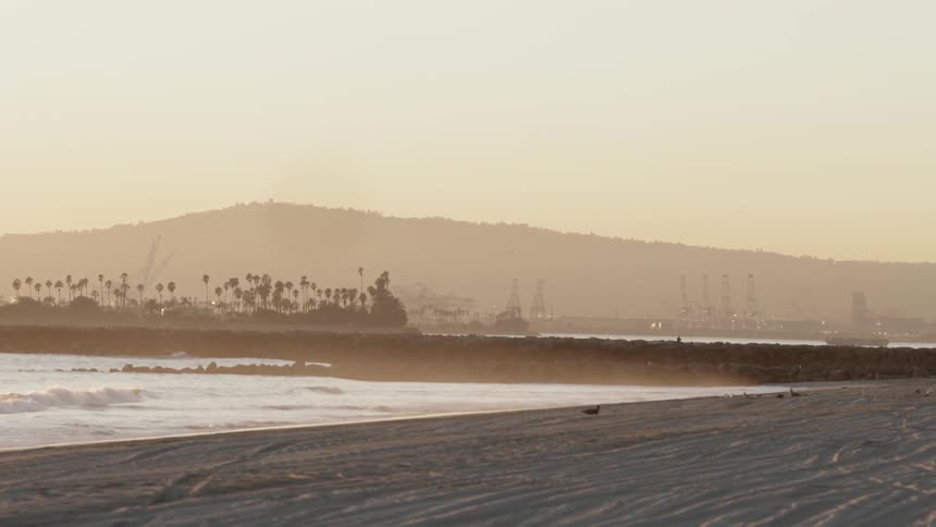 Waves rolling onshore on a hazy day