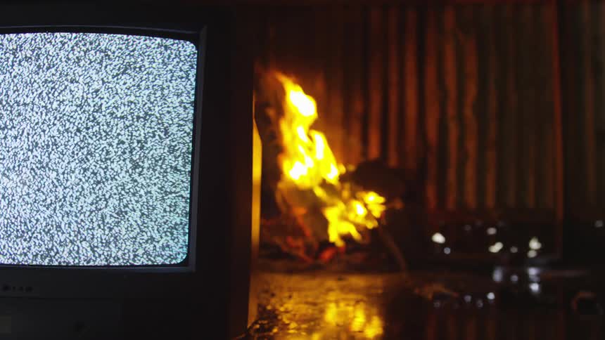 A fire is behind the flickering television