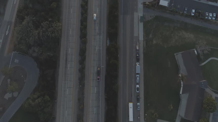 Cars driving down a road in a city