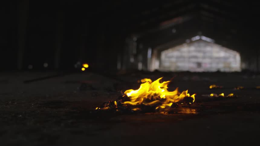 Abstract People Burning Various Objects In Warehouse