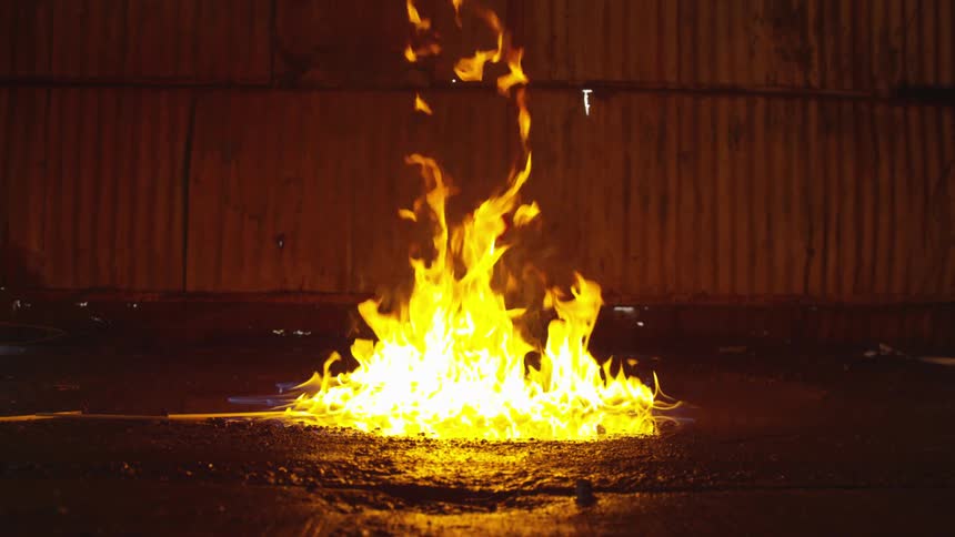 Abstract People Burning Various Objects In Warehouse