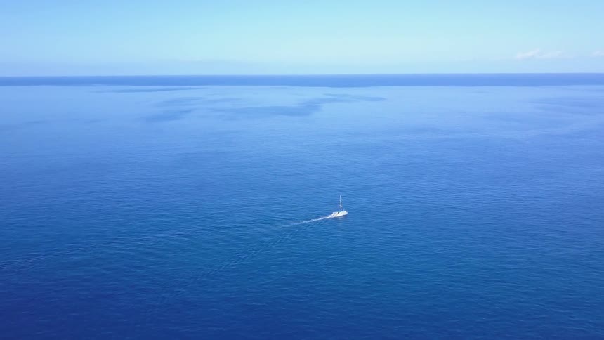 A boat sailing in the middle of the sea