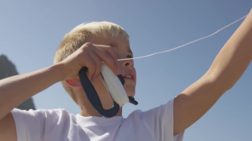 Boy Flying A Kite On The Beach
