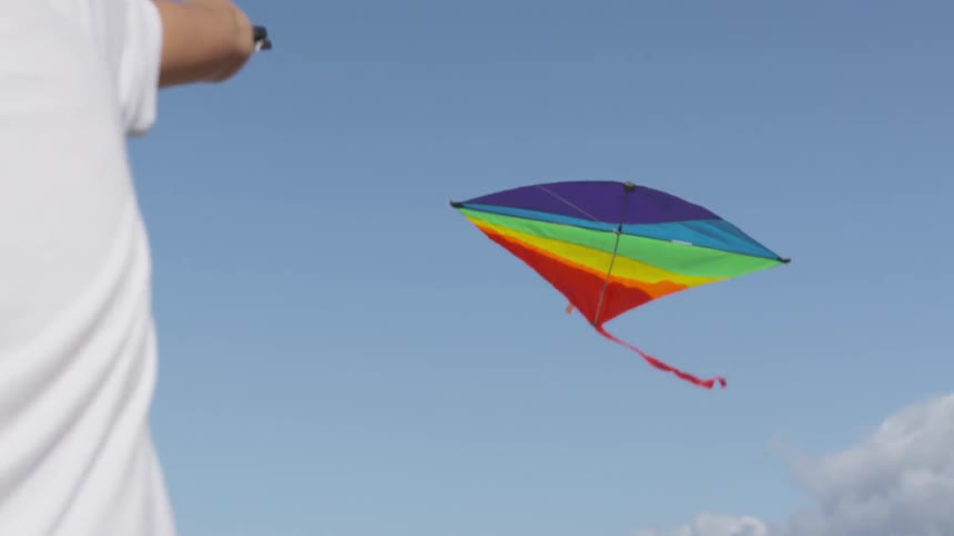 Boy Flying A Kite On The Beach