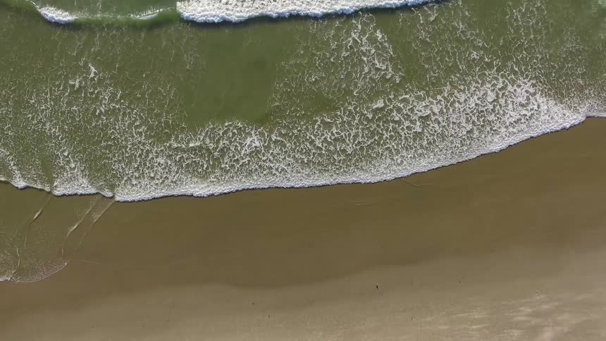 Ocean waves flow towards a shoreline