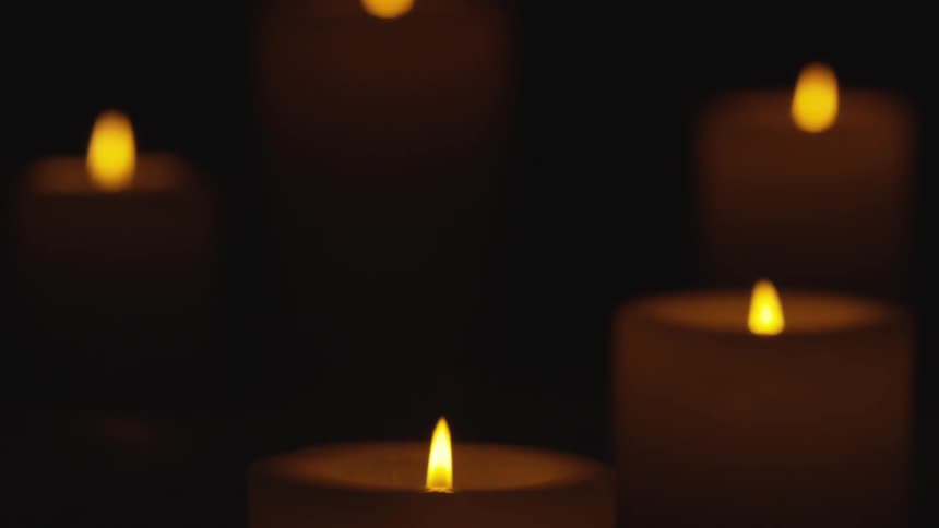 Candles burning in a dark room