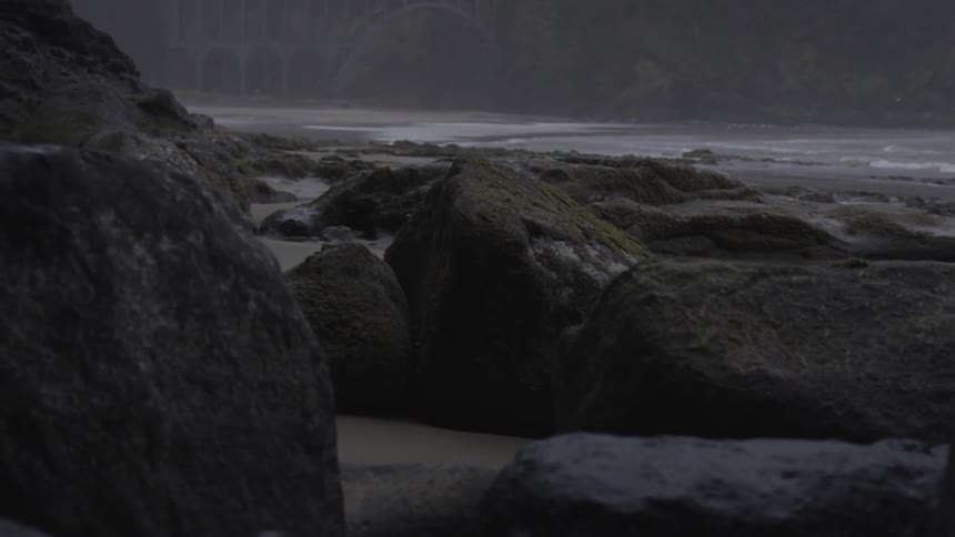 Rocks on the beach with waves rolling