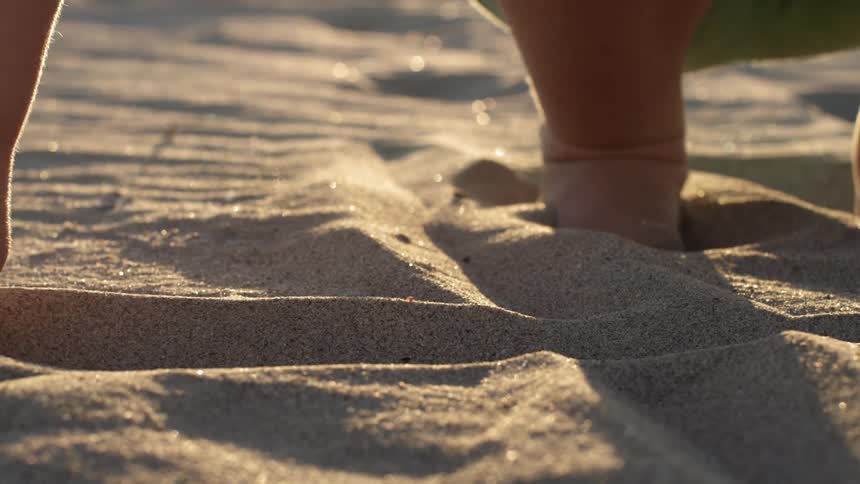 Child draws a line in the sand
