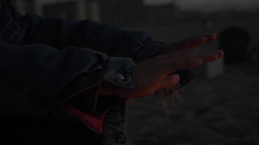 Man Building Fire On The Beach