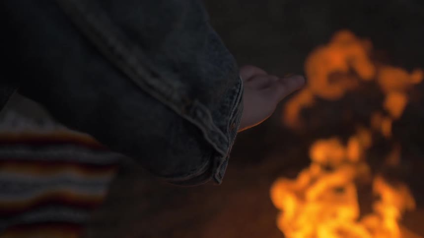 Man Building Fire On The Beach
