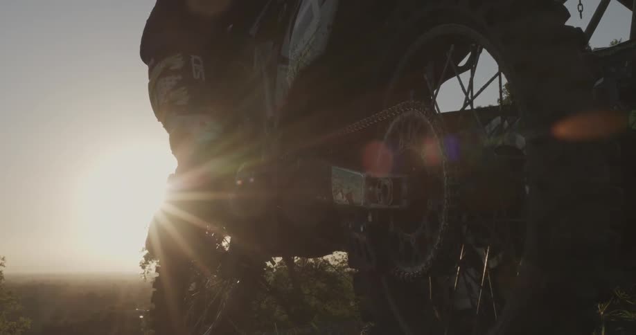 Bottom view of a motorcycle as a person sits on it