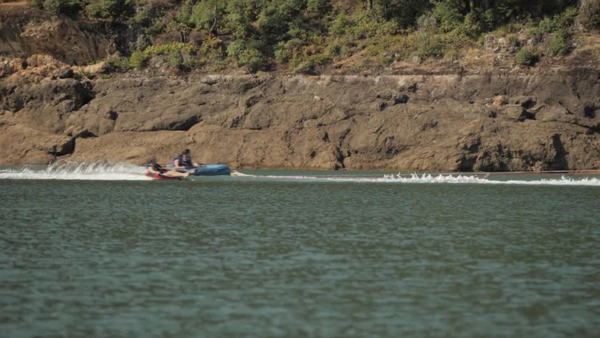 Man Driving Boat Around Lake