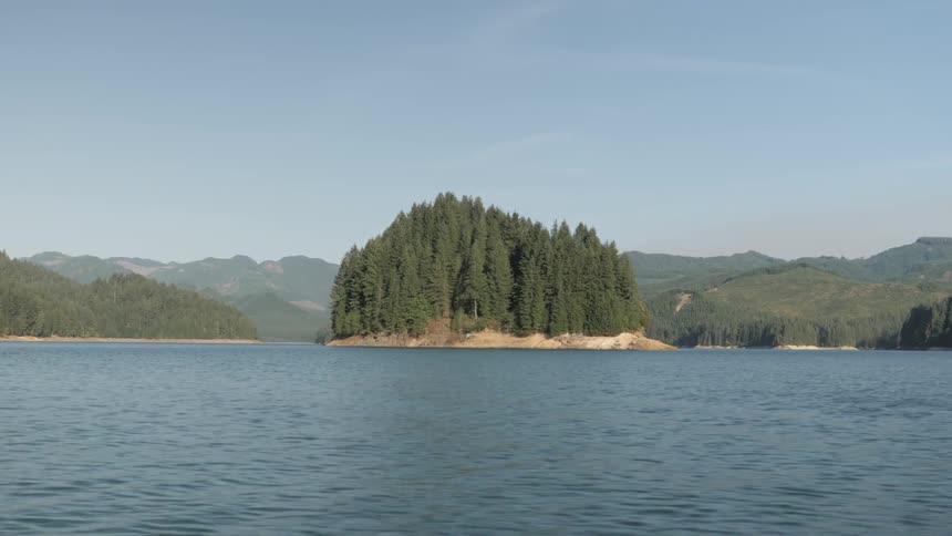 Man Driving Boat Around Lake