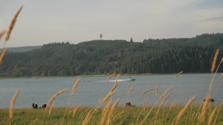 Man Driving Boat Around Lake