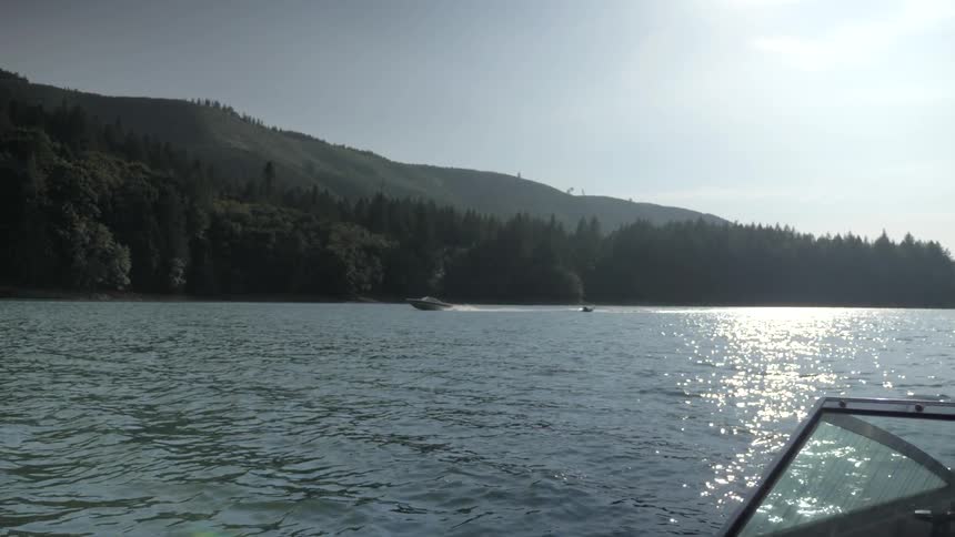 Man Driving Boat Around Lake