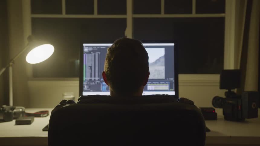 Man Editing Footage At Night