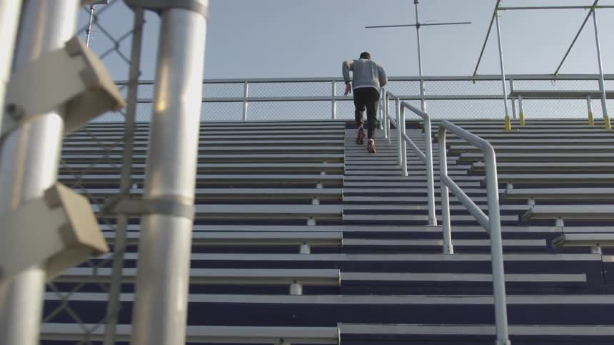Man Exercising At Stadium