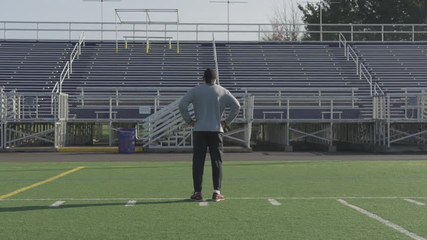 Man Exercising At Stadium