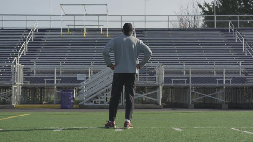 Man Exercising At Stadium
