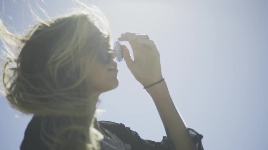 Woman walking outside moving her arms on a sunny day