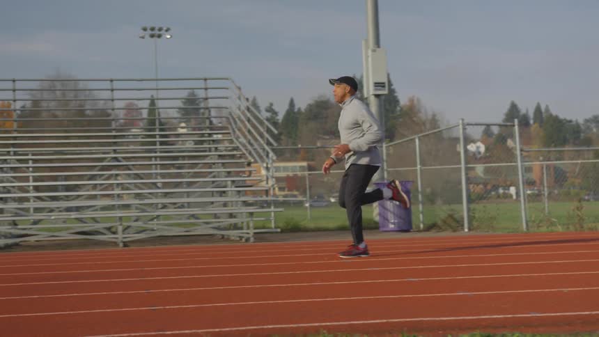 Man Exercising At Stadium