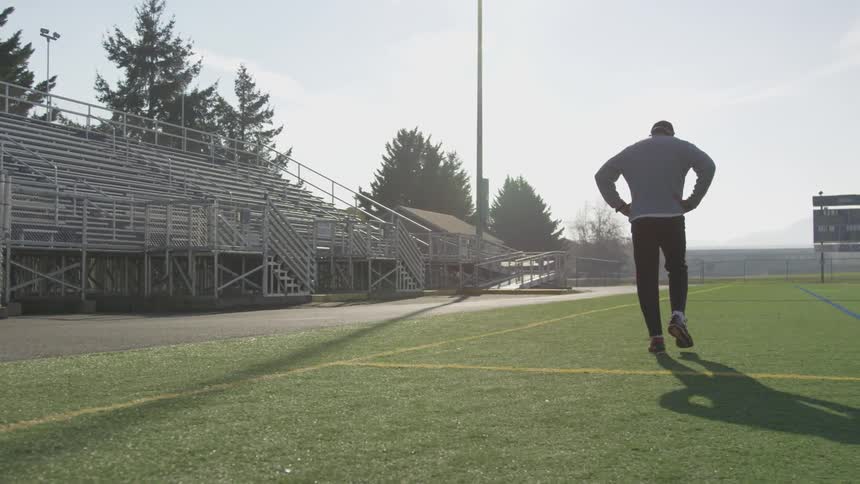 Man Exercising At Stadium