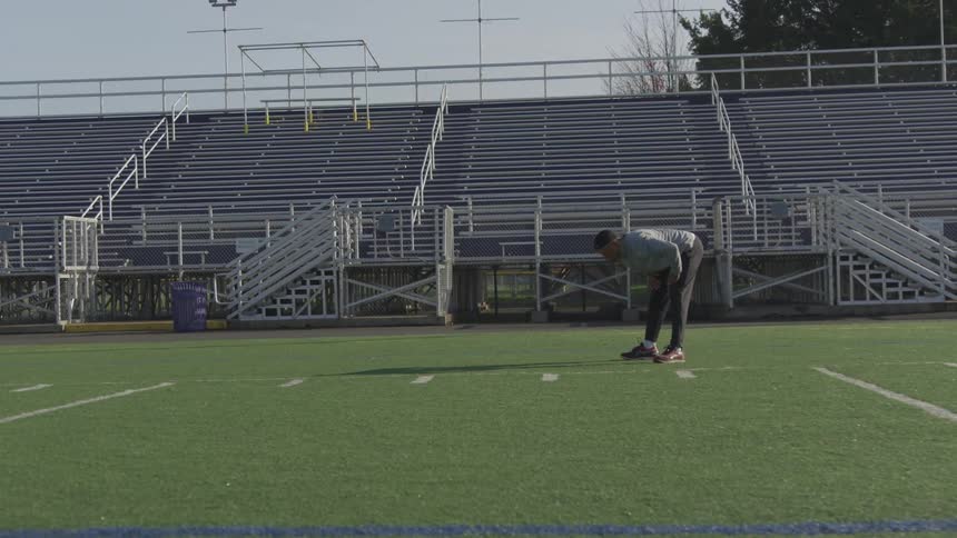 Man Exercising At Stadium